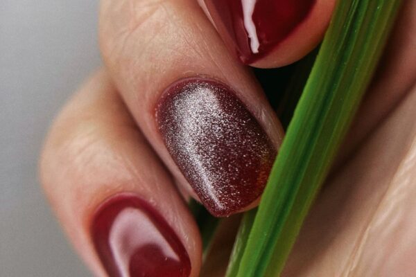 Dark red gel manicure with a magnetic shimmer accent nail