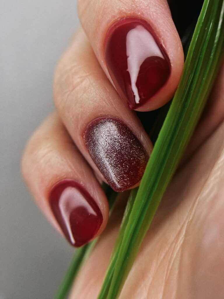Dark red gel manicure with a magnetic shimmer accent nail