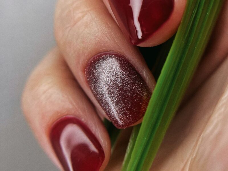 Dark red gel manicure with a magnetic shimmer accent nail